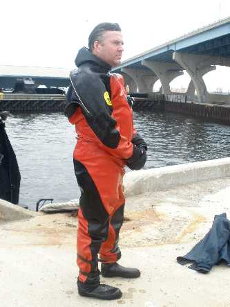 Diver stands patiently as he waits to be inspected for radio activity chemcials.