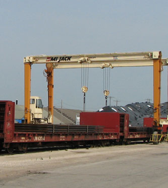 plate is being transloaded from rail car to truck