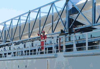 This waving crewman is happy to see Milwaukee. Some crewmen are at sea 7 months at a time.