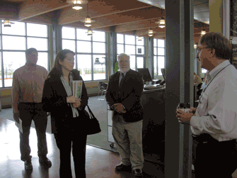 Women's Transportation Seminar took a tour of the Port on 9/27/06. The first stop was the Lake Express terminal. Ken Szallai, President of L.E. (right) stopped to talk to the group. Larry Sullivan, Port Chief Engineer was the tour guide, and Corinne Shary of EMC, Inc. (left) was one of 11 members taking the tour. Photo by Jennifer Lacke, HNTB