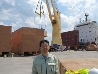 Yuuichi Kurosawa Assistant Mgr of Transportation Mgmt Section of Hitachi watches the unloading of 210 pieces for the Elm Road project